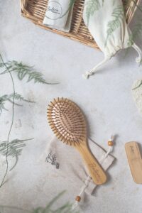 wooden hair brush near a woven basket